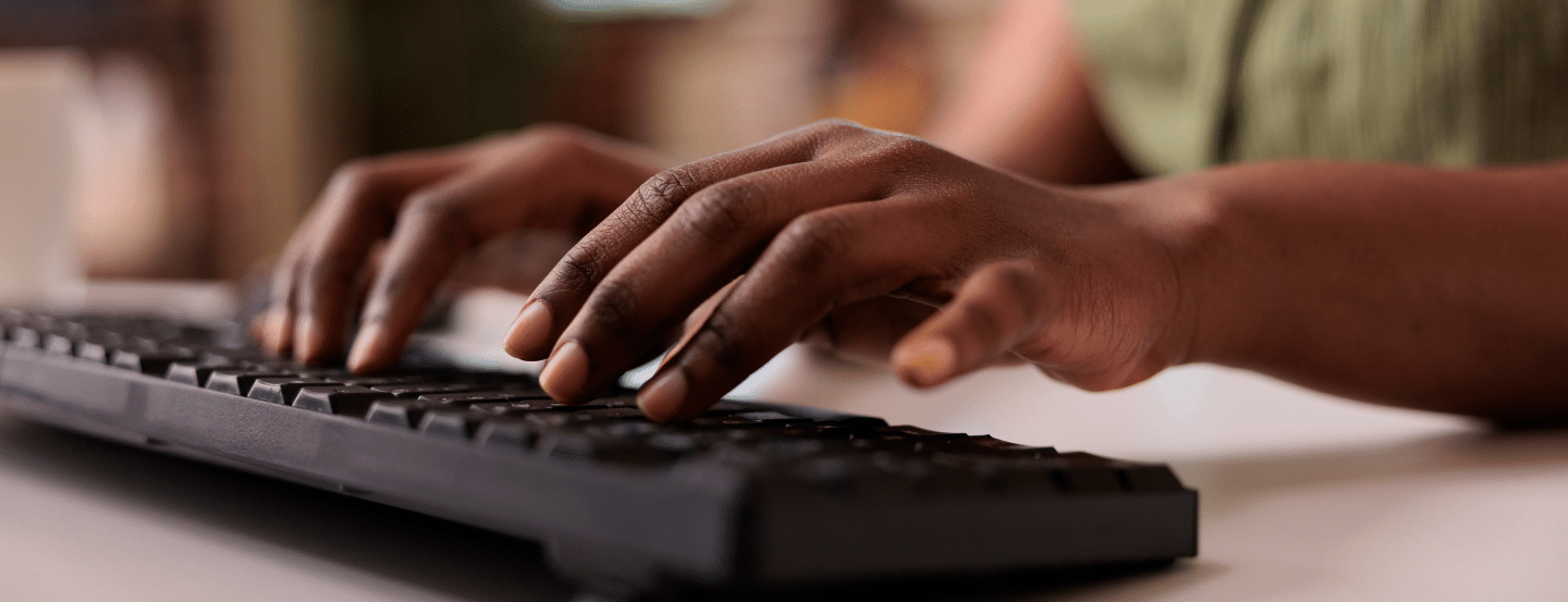 hands typing on computer keyboard