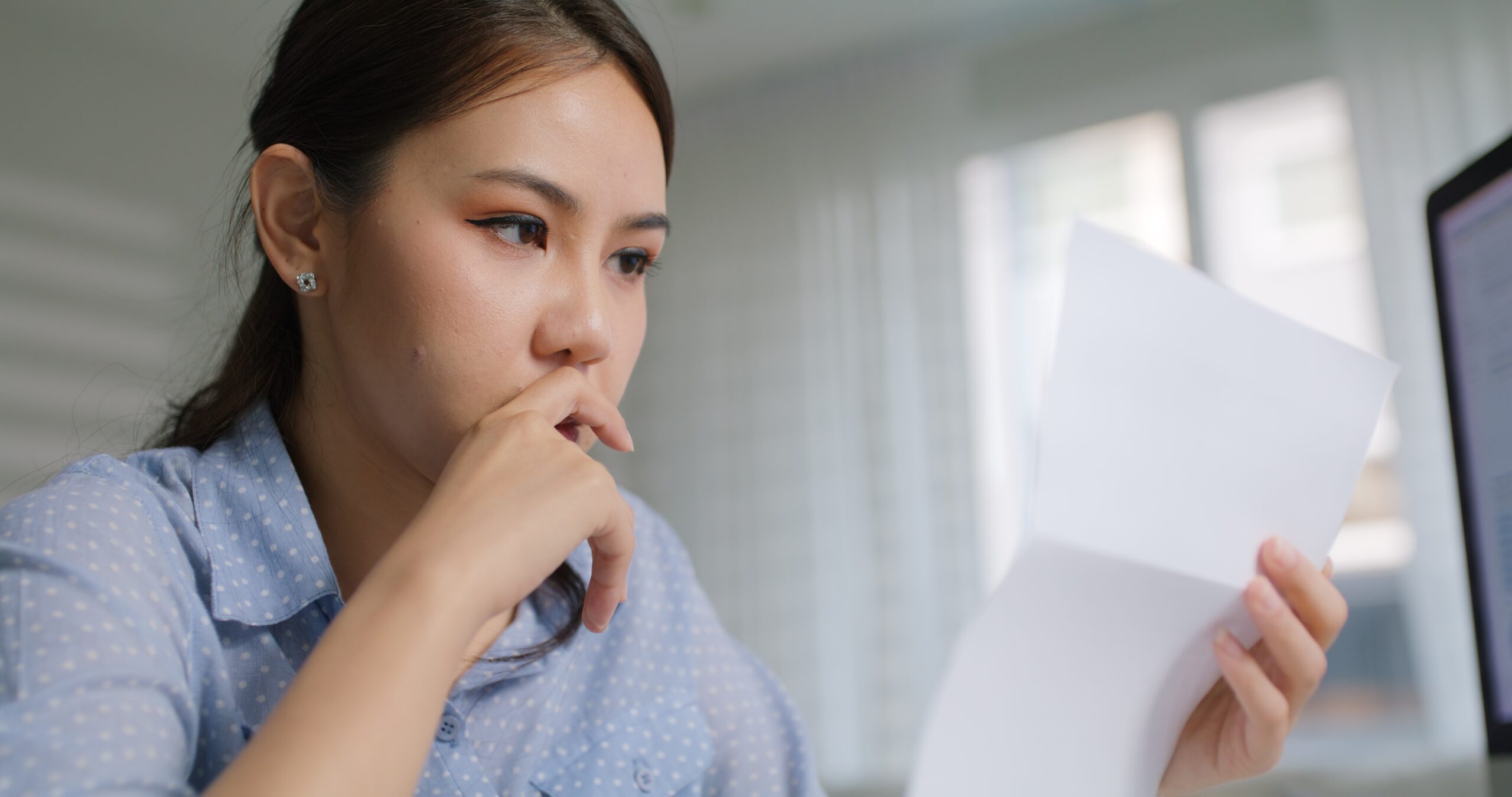 woman looking at letter